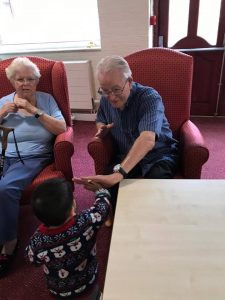 Children and elderly playing