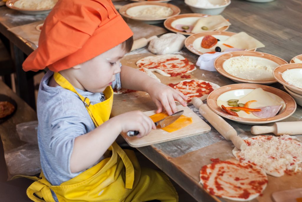 young child preparing food