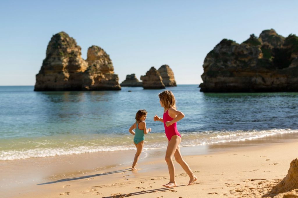 Children playing on the beach in Algarve, Portugal