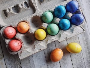 Decorated chicken eggs in an egg carton. Painted as an easter craft for little ones