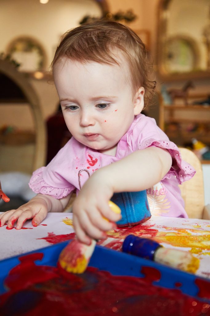 Baby learning through painting and sensory play