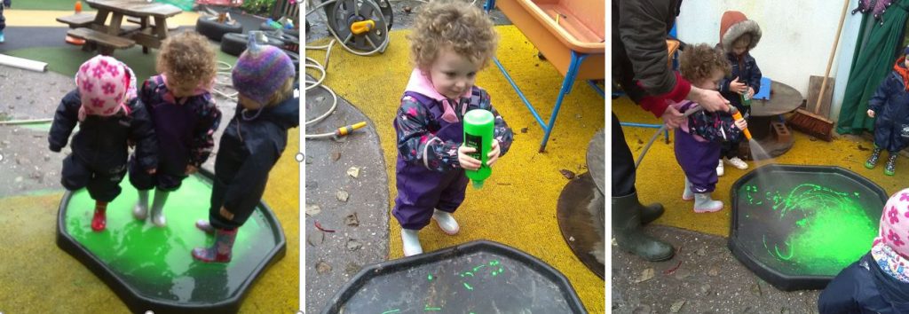 Children splashing in homemade colorful puddles
