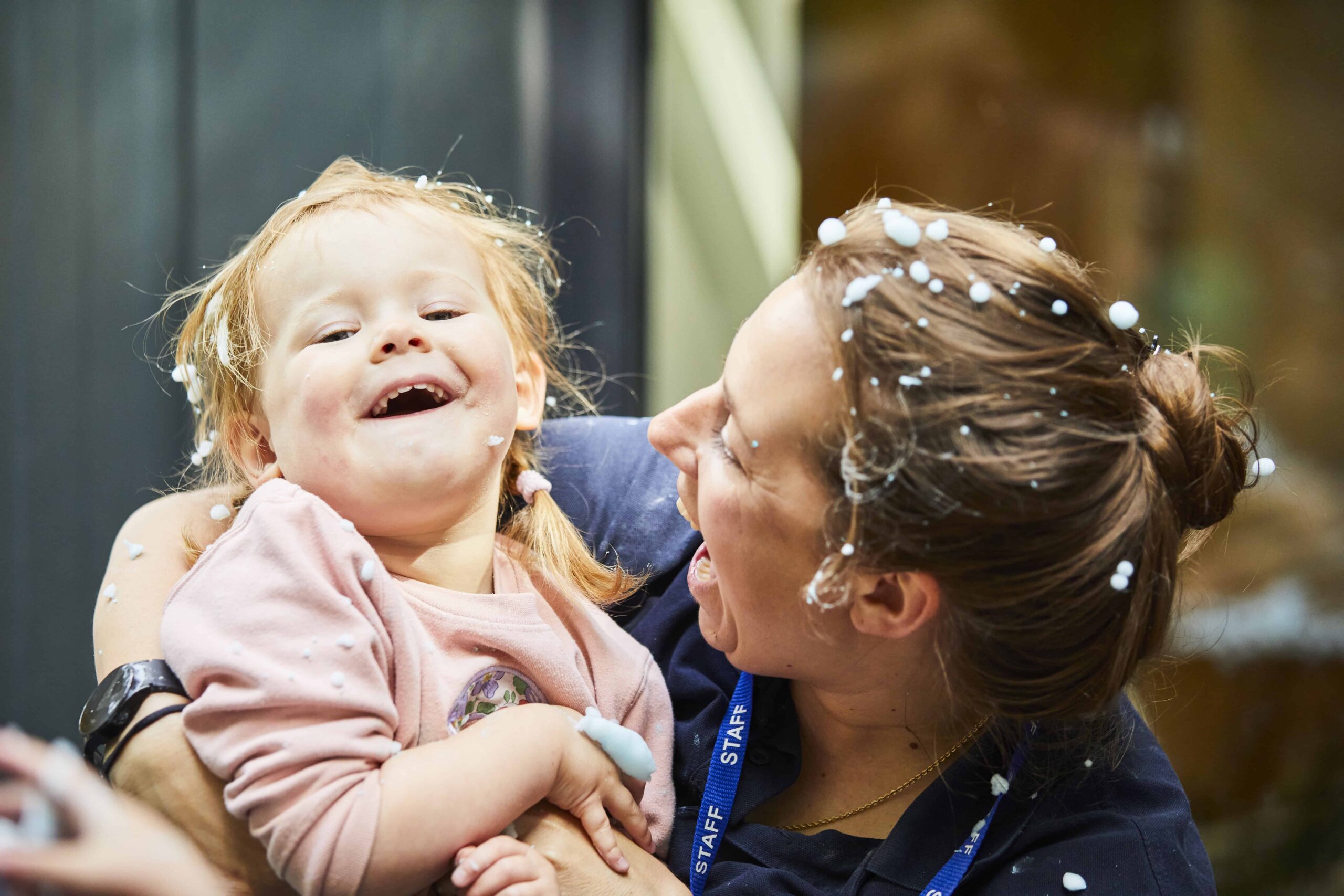 image of a toddler and a nursery staff member interacting