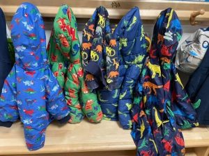 Coats labeled and hanging at nursery