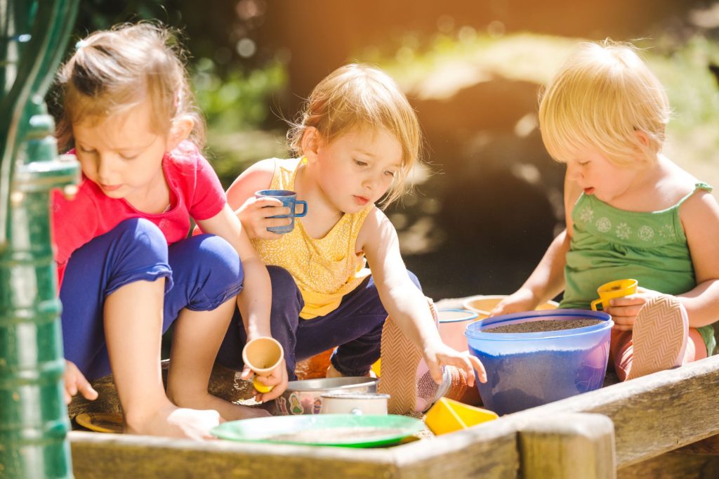 children playing outside at nursery