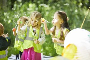 Kids Planet pre-schoolers blowing bubbles in the sunshine