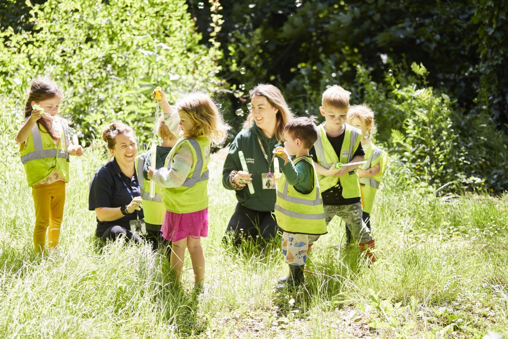 Baby playing outdoors in a forest setting